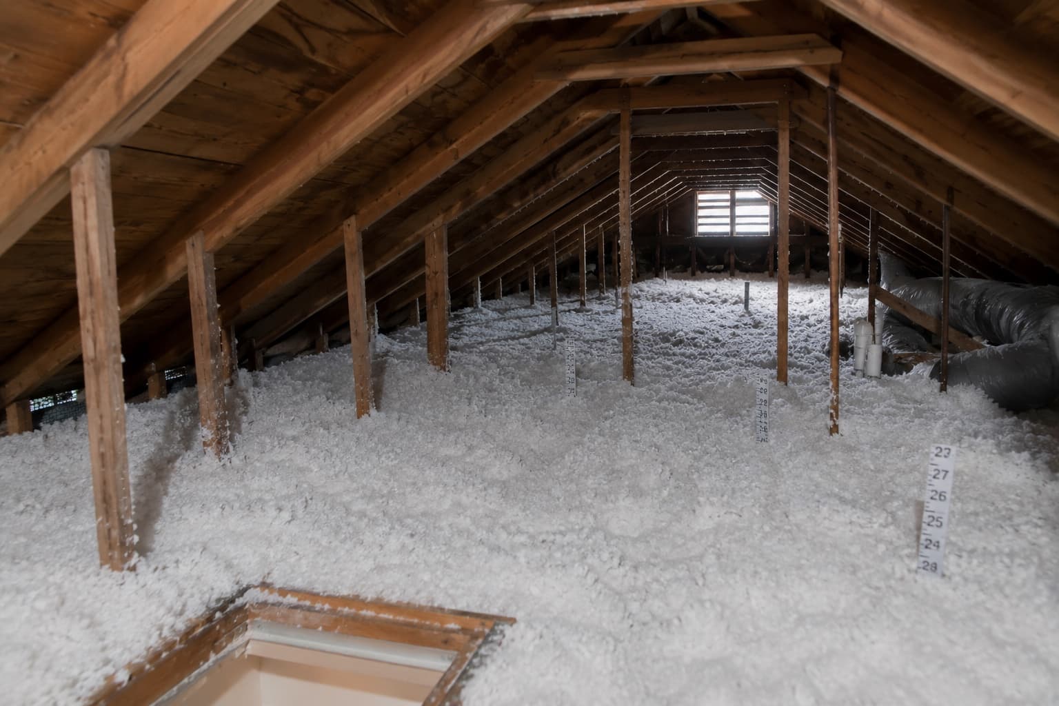 Danbury CT attic with clean joist bays filled with new blown-in insulation to a deep R-value after a Green Restoration project