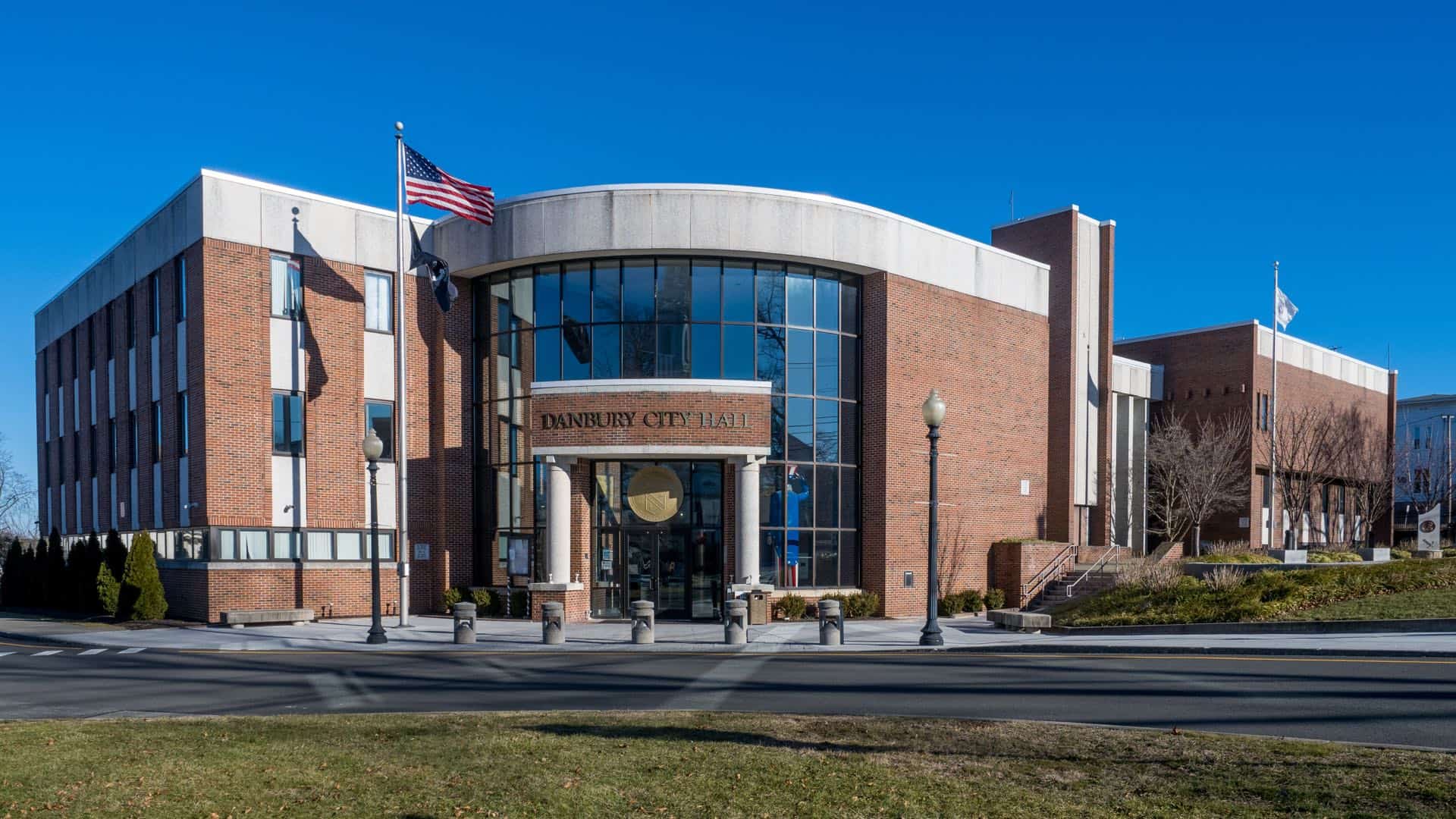 Danbury, Connecticut City Hall under a clear blue sky. Green Restoration provides 24/7 water, fire, mold, and storm damage restoration in Danbury, CT.